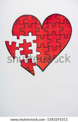 top view of drawn red heart shape jigsaw isolated on white with copy space