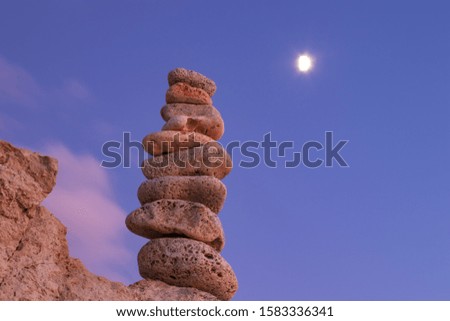 Object of stones on the background of the night sky and the moon. Zen stones. Harmony & Meditation