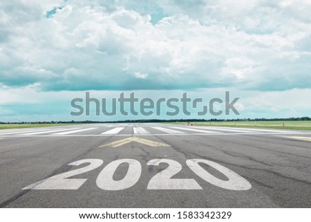 Airport runway with year 2020 letters in the foreground.