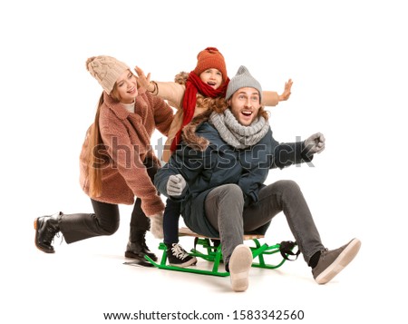 Happy family in winter clothes and with sledges on white background Royalty-Free Stock Photo #1583342560