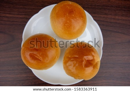 Round bread on white plate.
