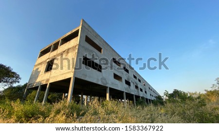 Wide scapes of deserted building and blue sky and grass. Abandoned buildings resulting in poor economic employment.