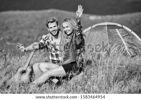 Love concept. Hiking romance. Couple in love happy relaxing nature background. Summer vacation. Boyfriend girlfriend guitar near camping tent. Camping vacation. Camping in mountains. Family travel.