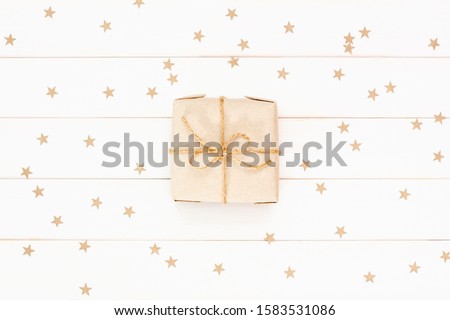 Gift and confetti on white background. Christmas banner, greeting cards, poster. Present craft box. Flat lay, top view
