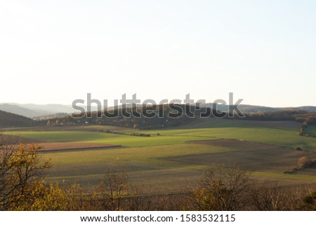 Setting sun on the left side and view of the countryside and surrounding nature panoramic view of the surrounding hills and overlooking the natural airport of Brno captured