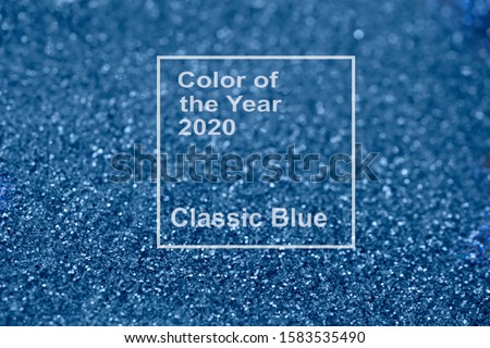 Beautiful Christmas multicolored light background with new 2020 year classic blue color. Abstract classic blue glitter bokeh and scattered sparkles