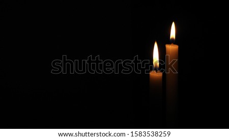 Orange red candle flame Illuminated on colored candles White night black background