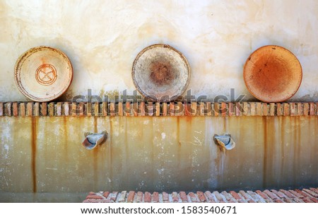 Ceramic decorative objects in the yard of a typical Andalusian farmhouse located in the fertile farmlands near the city of Seville