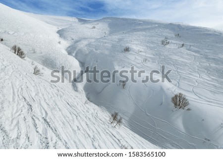 Beautiful mountain covered snow in alpine ski resort Krasnaya Polyana in Russia. Cold winter sunny day, wonderful view in mountains. Rest and sport.