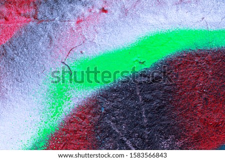 Fragment of colored graffiti painted on a wall. Bright abstract background for design.