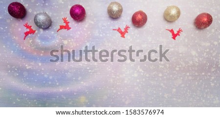 Christmas card with colorful baubles and reindeers.