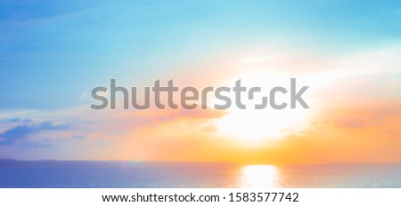 bright orange sunrise on the sea on a summer day, view from the bridge,blurred background