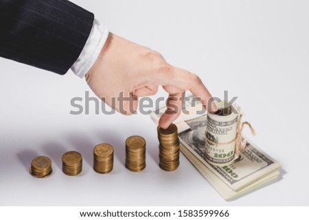 Finger of businessman walking up Growing Money graph symbol of a successful profitable transaction. 