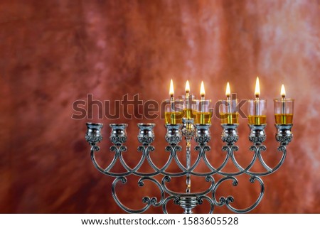 Fifth day of the Jewish holiday Hanukkah six Hanukkah candles are burning on light of menorah