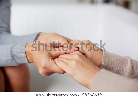 Close-up of psychiatrist hands holding those of her patient Royalty-Free Stock Photo #158366639