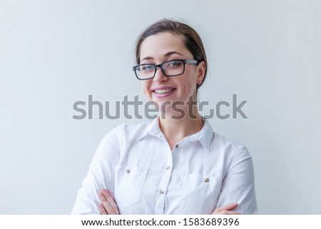 Beautiful happy girl smiling. Beauty simple portrait young smiling brunette woman in eyeglasses isolated on white background. Positive human emotion facial expression body language. Copy space.