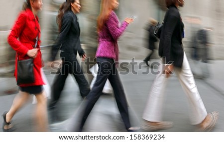 Business people at rush hour walking in the street, in the style of motion blur
