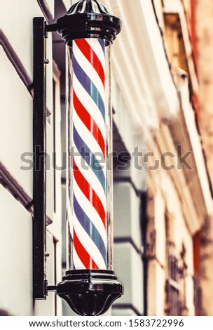 Barber shop pole. Logo of the barbershop, symbol. Barbershop pole, retro. Old fashioned vintage barber shop pole. A classic barber logo.
