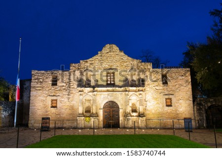 The Alamo Mission at night in downtown San Antonio, Texas, USA. The Mission is a part of the San Antonio Missions World Heritage Site.