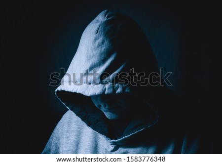 Mysterious man wearing hood suitable for various concepts