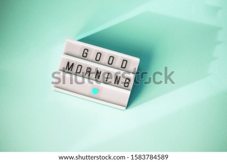 Lightbox with the words good morning on a mint background. Flat lay Top view Concept of rest, relax, time to sleep