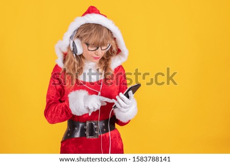 santa claus with mobile phone and headphones