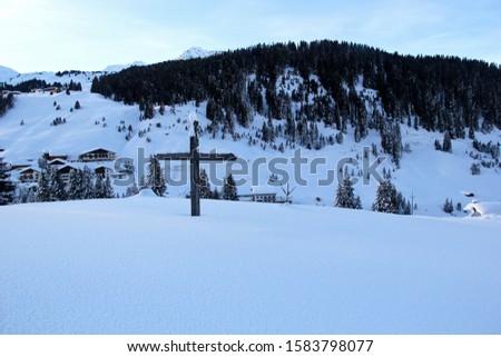 Cross at the Winter Mountain Peak at the Austrian Alps, in Lech am Arlberg 