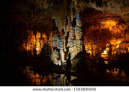 Towering stalagmite formations in a cave Royalty-Free Stock Photo #1583800606