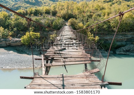 Old ruined foot bridge over the Vjose in Permet Albania. photographed in perspective  Royalty-Free Stock Photo #1583801170