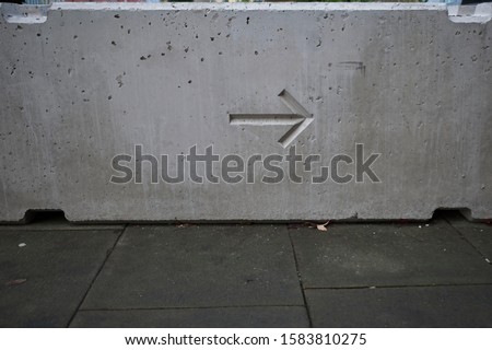 Concrete barrier with direction arrow