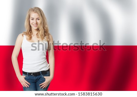 Cute young woman on the Poland flag background. Travel and learn polish language concept Royalty-Free Stock Photo #1583815630