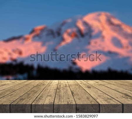 Wooden table top on winter sunny landscape with fir trees. Merry Christmas and happy New Year greeting background. Winter landscape with snow and christmas trees.Wooden table top on winter sunny lands