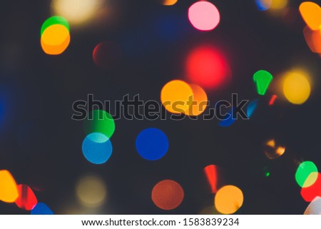 Bokeh christmas lights. Holiday background. Garland. Glitter. Defocused blinks. New Year. Bokeh retro style photo.