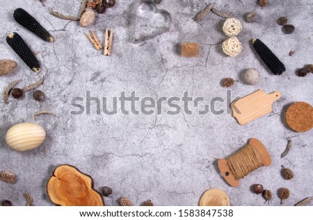 Zero waste background. On gray asphalt, wooden objects - heart, egg, clothespin and nuts. Composition without plastic. Shot from above. Beautiful flat lay.
