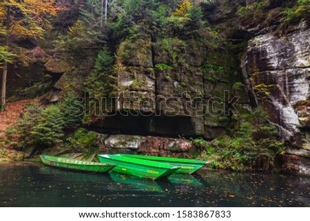River with autumn leaves and boulders on the river Kamenice in Bohemian Switzerland. Near the Wild Gorge.