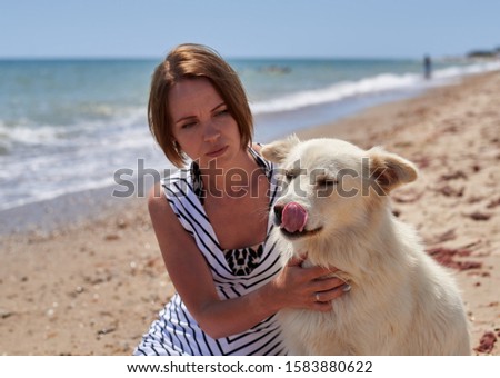 woman with dog on the beach