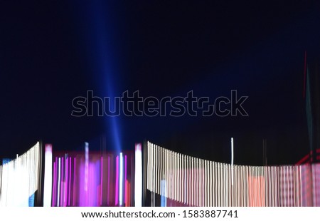 illustrated blurry fast moving flashes night light with blue laser rays up through darkness as background