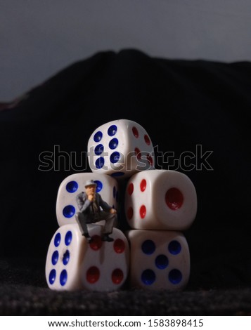 Black Background Photo, Sitting Man Holding Smartphone at white plastic Dice, Illustration for Online Gamble
