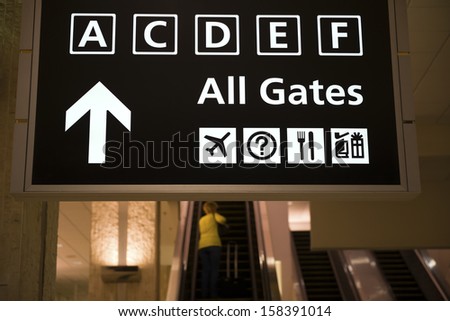 departure gates sign and escalators