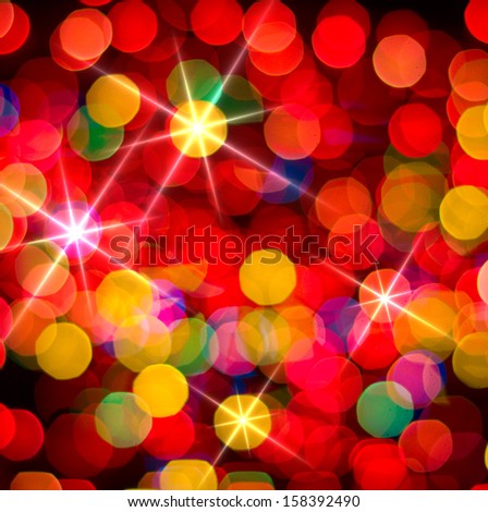 Multi-colored glowing background. Christmas card. Abstract background with bokeh defocused lights and stars