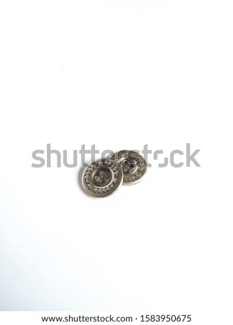 two shiny copper buttons with a white background