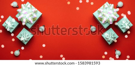 New years background. Christmas gifts with white ribbon on red background. Xmas present. Winter holiday concept. Merry Christmas and Happy Holidays greeting card, frame, banner