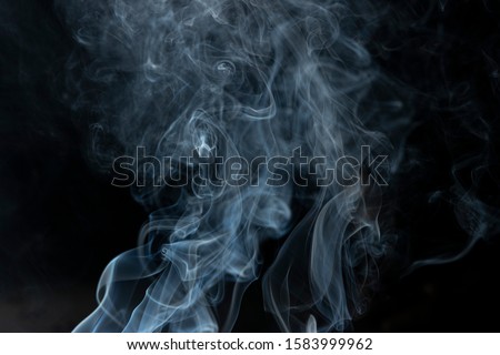 white smoke or fog blow to up against dark background - Image, good for food photography to show sizzlers, sizzling food, grilled cooking, grilled dishes, smoke in white background Royalty-Free Stock Photo #1583999962