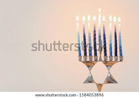 Religion image of jewish holiday Hanukkah background with david star menorah (traditional candelabra) and candles