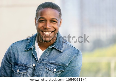 Close up head shot of a handsome commercial african american model with perfect white teeth smile after dentist, dental and orthodontic advertisement Royalty-Free Stock Photo #1584061174