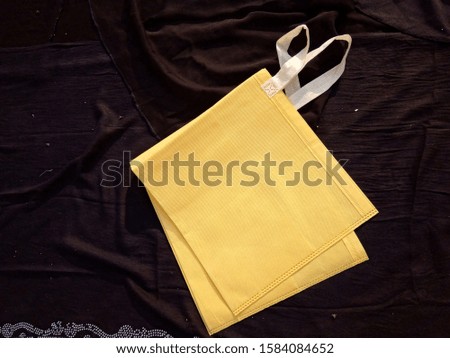 Handle loop yellow non woven bag on black