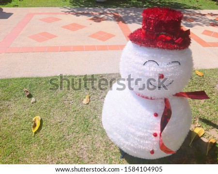 white snowball with red hat on christmas