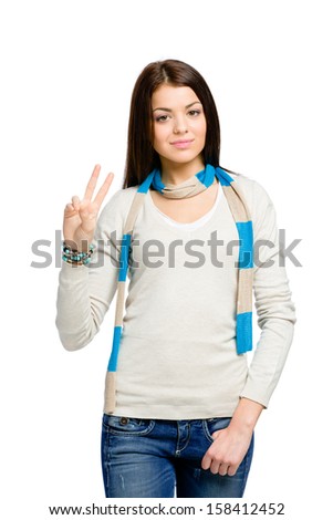 Teenager gesturing victory sign, isolated on white