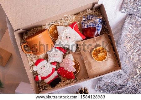 Christmas gift box with jam, ginger cookies and oranges, new year present