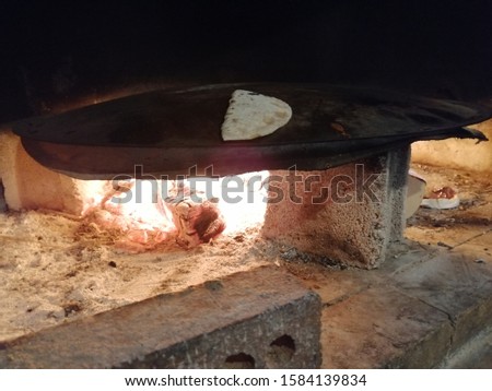 peasant women making bread over fire